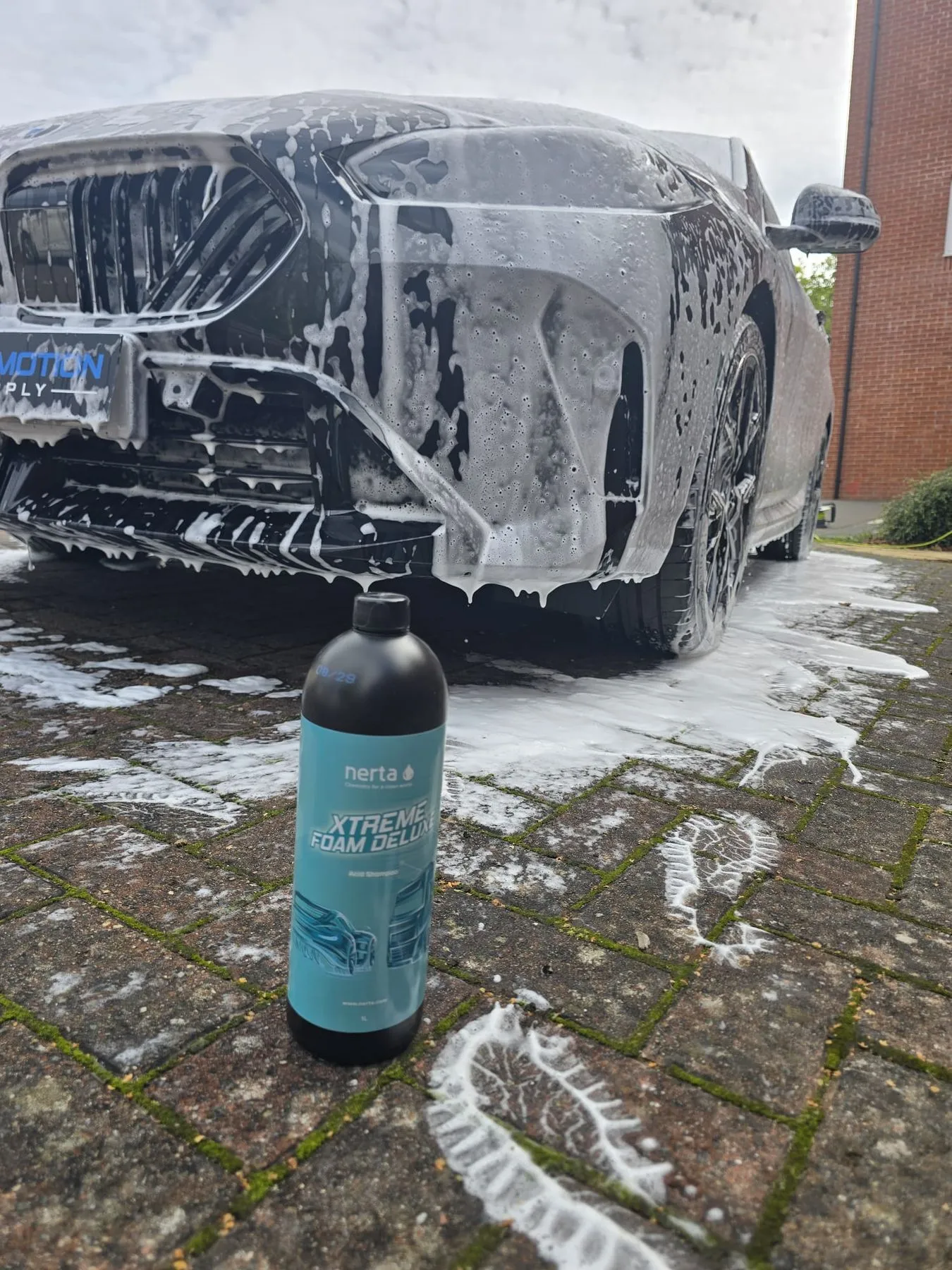 BMW covered in Nerta Xtreme Foam Deluxe snow foam during a pre-wash